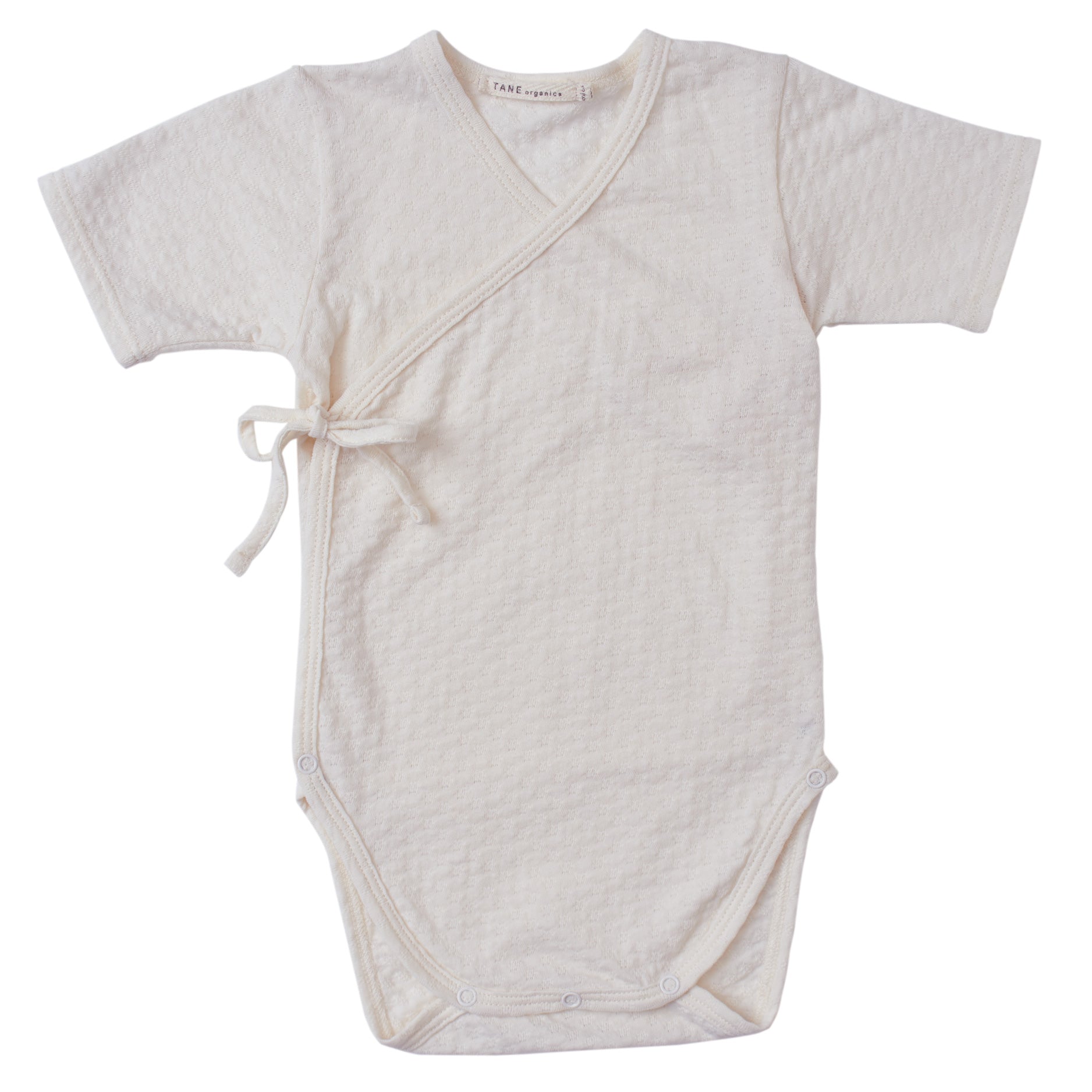 cream color pointelle short sleeved double front kimono wrap onesie. 100% organic cotton.